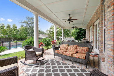 Photo of a classic veranda in New Orleans with brick paving.