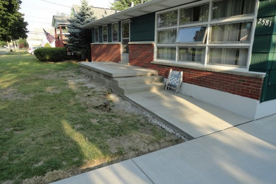 This is an example of a concrete front porch design in New York.