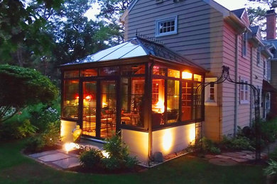 Inspiration for a mid-sized timeless stone screened-in side porch remodel in New York with a roof extension