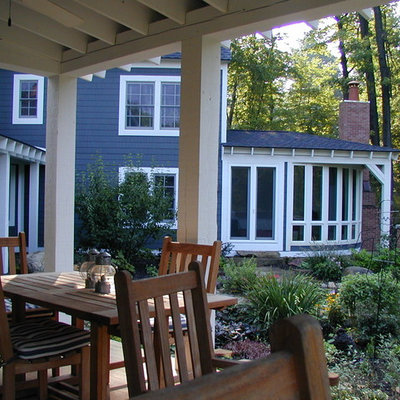 This is an example of a mid-sized farmhouse back porch design in Detroit with decking and a roof extension.