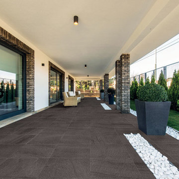 Contemporary porch with dark brown porcelain tile