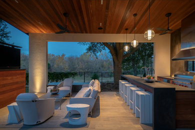 Large minimalist tile porch photo in Austin with a roof extension