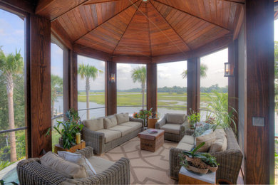 This is an example of a tropical porch design in Charleston.