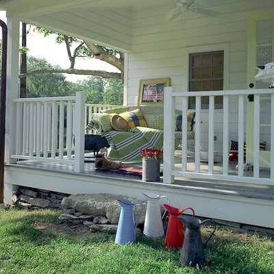 Inspiration for a farmhouse porch remodel in New York with decking and a roof extension