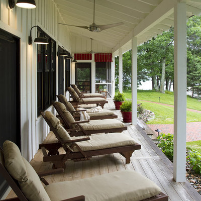 Farmhouse porch idea in Minneapolis with a roof extension