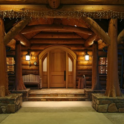 Large mountain style stamped concrete front porch idea in Other with a pergola