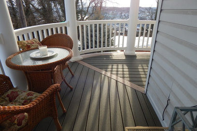 This is an example of a mid-sized victorian front porch design in Other with decking.