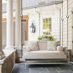 Inspiration for a small transitional backyard verandah in Atlanta with a roof extension and tile.