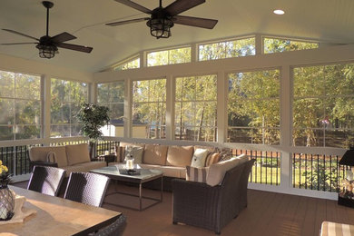 Mid-sized classic screened-in back porch idea in Charlotte with decking and a roof extension