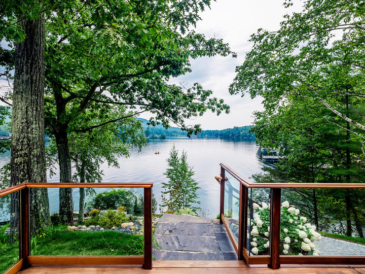 Idea for a large, mountain-style back porch with decking and a fire pit.