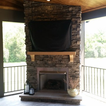 Custom stone fireplace with stainless gas insert and porcelain tile floor