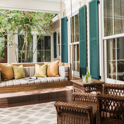 Trendy front porch idea in Atlanta with a roof extension and decking