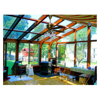 Dark stained, gabled sunroom with pellet stove - Classique - Porche ...