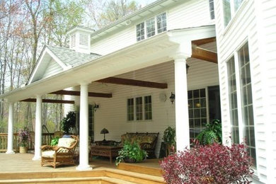 This is an example of a large traditional back porch design in Cleveland with decking and a roof extension.
