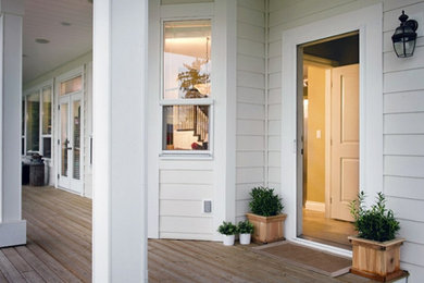 Mid-sized farmhouse front porch idea in Los Angeles with decking and a roof extension