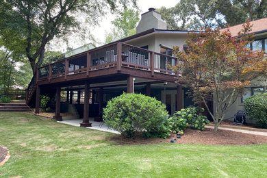 This is an example of a large contemporary porch design in Atlanta with decking and a roof extension.