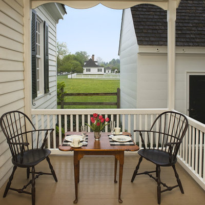 This is an example of a country porch design in Other with decking and a roof extension.