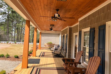 Inspiration for a mid-sized rustic front porch remodel in Atlanta with decking and a roof extension
