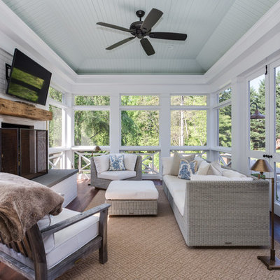 Inspiration for a farmhouse screened-in porch remodel in Other with decking and a roof extension
