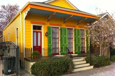 This is an example of a medium sized victorian front veranda in New Orleans with a roof extension.