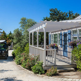 Mid-sized beach style porch photo in Boston with decking and a pergola