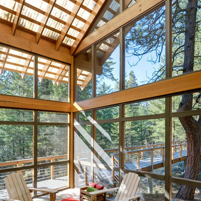 Large trendy screened-in porch photo in Seattle with decking and a roof extension