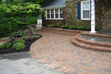 Large trendy concrete paver porch idea in Philadelphia with a roof extension