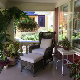 Immagine di un portico american style di medie dimensioni e davanti casa con un giardino in vaso, pedane e un tetto a sbalzo