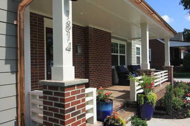 Mid-sized transitional stamped concrete front porch idea in Other with a roof extension