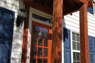 Inspiration for a small craftsman brick front porch remodel in Charlotte