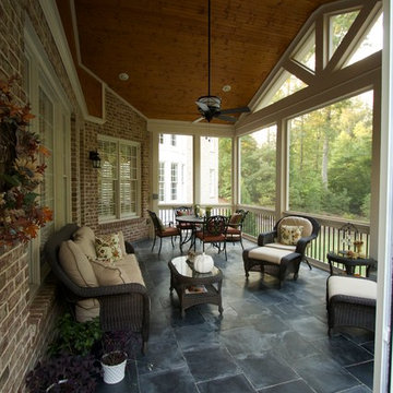 Gable screen porch with tile floor and spiral staircase