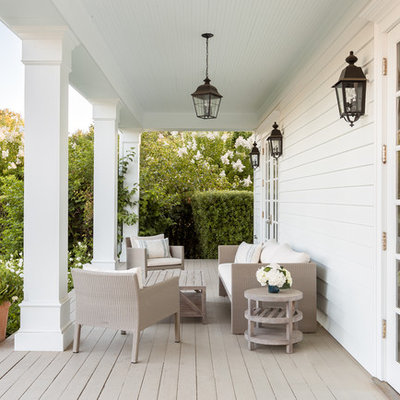 This is an example of a country porch design in San Francisco with decking and a roof extension.