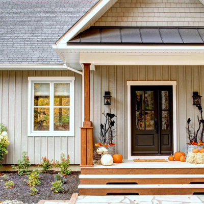 Large country porch photo in Montreal with a roof extension