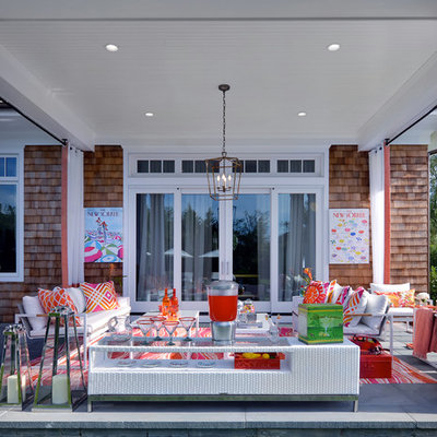 Mid-sized beach style concrete paver back porch photo in New York with a roof extension