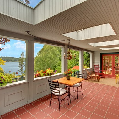 Country tile porch photo in Seattle with a roof extension