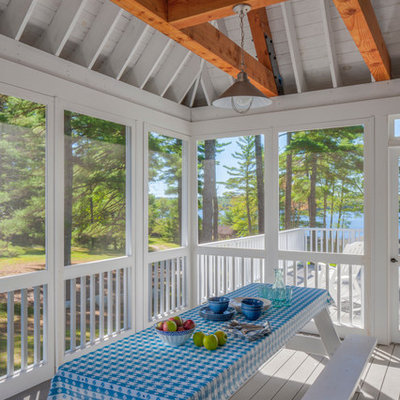 Cottage screened-in porch idea in Portland Maine with decking and a roof extension