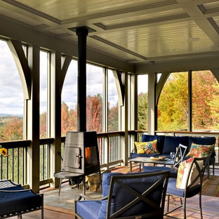 Classic screened-in porch idea in Burlington with decking and a roof extension