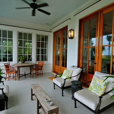 This is an example of a traditional porch design in Charleston with decking and a roof extension.