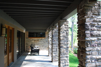 This is an example of a cottage porch design in New York.