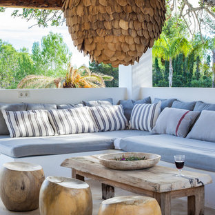 This is an example of a mediterranean veranda with a pergola.