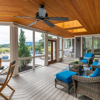 Mid-sized beach style screened-in back porch idea in Boston with a roof extension and decking