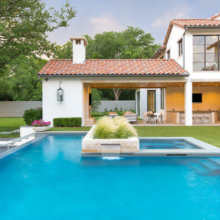 Foto di un ampio portico mediterraneo dietro casa con pavimentazioni in pietra naturale e un tetto a sbalzo