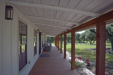 Inspiration for a large cottage concrete paver front porch remodel in Austin with a roof extension