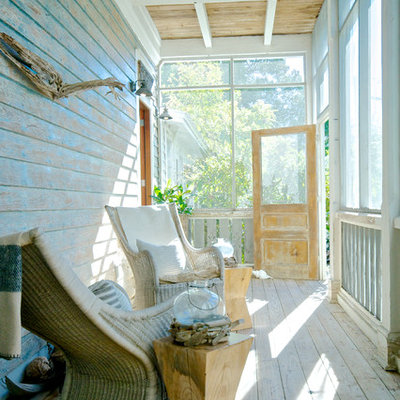 Beach style screened-in porch photo in Jacksonville with a roof extension