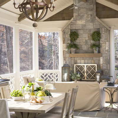 Mid-sized beach style stone screened-in back porch idea in Other with a roof extension