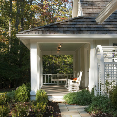 This is an example of a coastal porch design in DC Metro with a roof extension.
