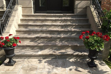 Mid-sized classic concrete paver front porch idea in Toronto with a roof extension