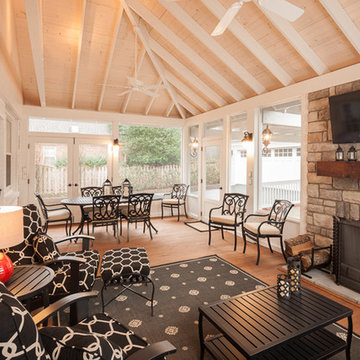 Light and airy screened porch with stone veneered fireplace