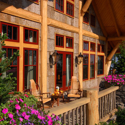Inspiration for a large rustic front porch remodel in Charlotte with decking and a roof extension