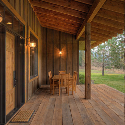 This is an example of a mid-sized rustic porch design in Seattle.